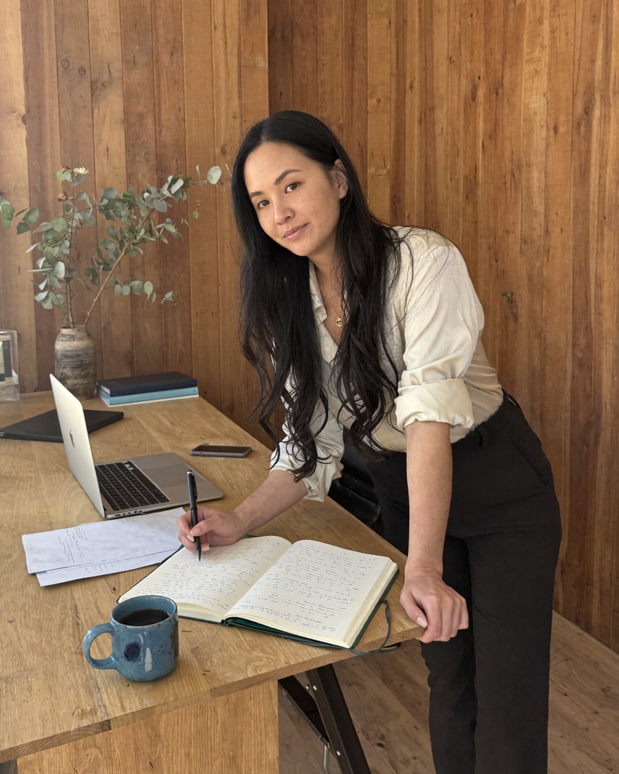 Jenn Yang at her Melbourne desk reviewing notes for an AI build